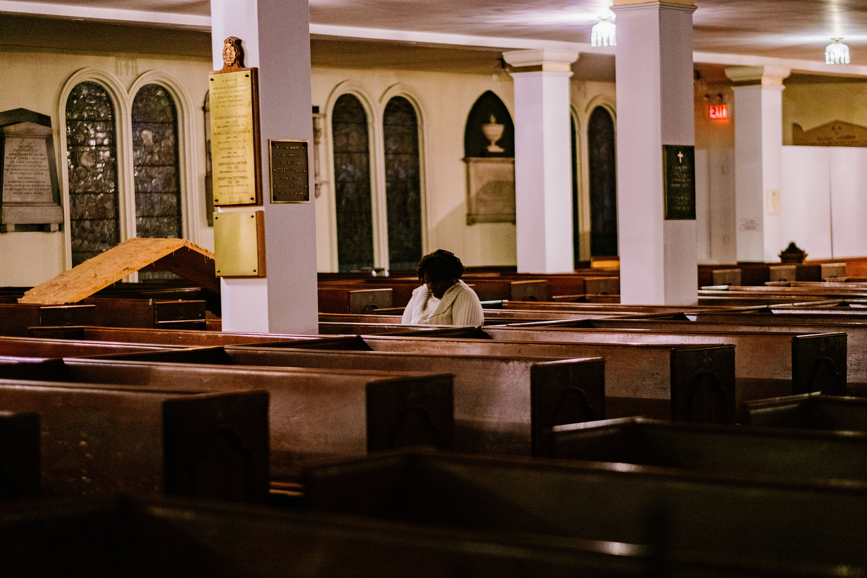 A woman prays in a church.